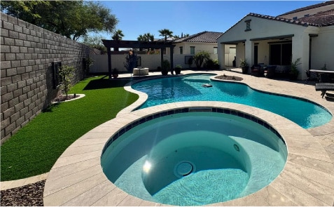 Elegant Pool with Built-In Spa, Artificial Turf, and Modern Patio