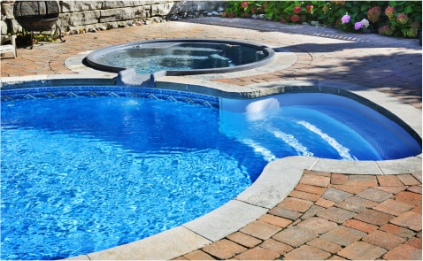 Modern Pool and Spa with Curved Edges and Stylish Brick Paving