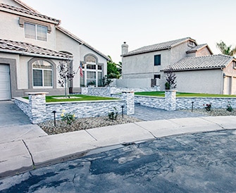 Gilbert Home exterior with custom stone retaining walls and artificial grass in Gilbert