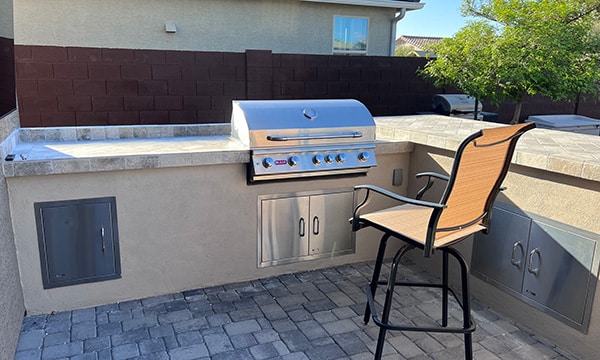 Custom Landscape Construction Featuring Outdoor Grill and Seating